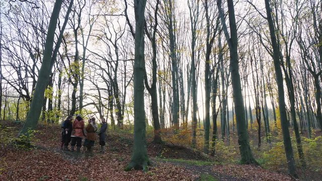 Medieval Vikings talking in the forest.