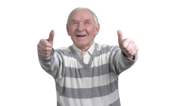 Old man with two thumbs up. Happy senior man giving two thumbs up, isolated on white background. Human facial expressions and body langauge.