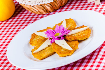 Potato pancakes with cheese on white plate
