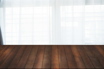 brown wood office table with free space for text on white curtain windows texture background.