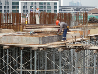 Construction workers fabricated timber form work at the construction site. Form work made from...