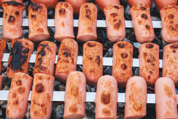 Roasting sausages on the fire, close-up view