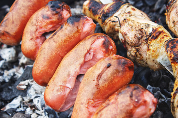 Roasting sausages on the fire, close-up view