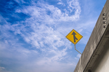 Merge road sign on sky