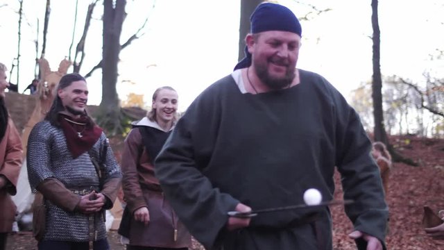 Vikings have some fun. Viking play with egg, bringing eggs on a sword
