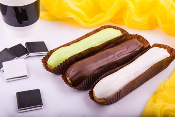 A dessert three layers of chocolate pleasure in a mousse combination from white, milk and bitter chocolate on a dark biscuit