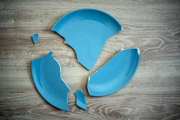 Broken blue dish on the floor