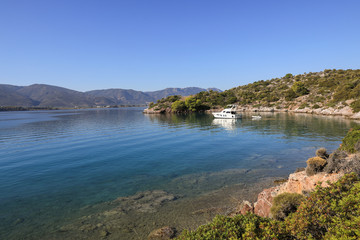 Fototapeta na wymiar Summer time a beautiful yacht anchoring in Love bay Poros island Greece.