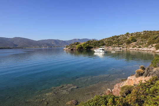 Fototapeta Summer time a beautiful yacht anchoring in Love bay Poros island Greece.