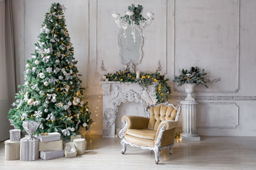 Fototapeta na wymiar Christmas morning . classic apartments with a white fireplace, decorated fir tree, sofa, large windows and chandelier.