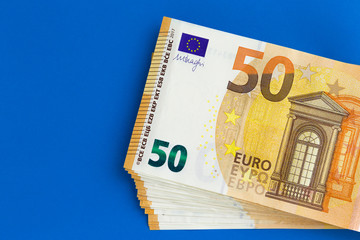 Fifty euro note on a blue background.