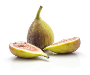 One whole fig and two sliced halves with rose flesh isolated on white background ripe fresh purple green.