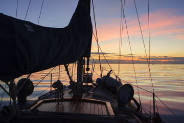 A sailboat preparing to depart in the morning light in the Bahamas.