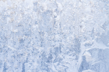 Winter frosty patterns on the frozen ice window