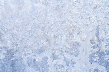 Winter frosty patterns on the frozen ice window