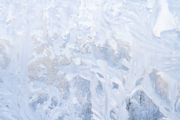 Winter frosty patterns on the frozen ice window