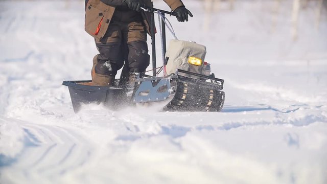 Mini snowmobile overcoming deep snow