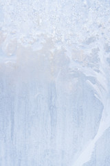Winter frosty patterns on the frozen ice window