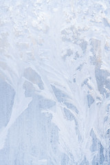 Winter frosty patterns on the frozen ice window