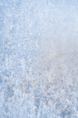 Winter frosty patterns on the frozen ice window