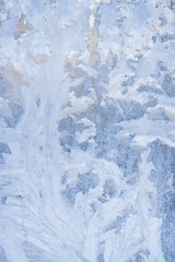 Winter frosty patterns on the frozen ice window