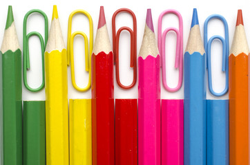 set of colored pencils and paper clips isolated on white