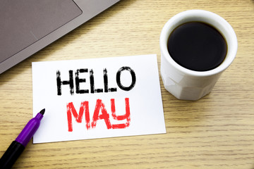 Handwriting Announcement text showing Hello May Month. Business concept for Coming Spring Month written on notebook book on the wooden background in the Office with laptop coffee