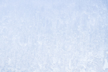 Winter frosty patterns on the frozen ice window