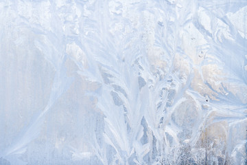 Obraz na płótnie Canvas Winter frosty patterns on the frozen ice window