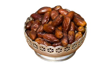 Dried date fruits in silver bowl isolated on white background