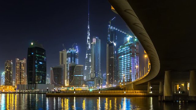 Panoramic view of business bay and downtown area of Dubai, reflection of night illumination of skyscrapers in Dubai creek. UAE