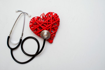 Medicine. Pressure sensor, heart shape, stethoscope and dollars on a wooden background, copyspace