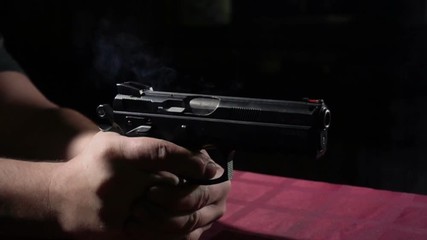 Close up of 9 mm handgun. Shooting at super slow motion 500FPS