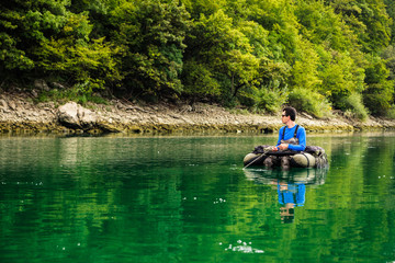 Fototapeta na wymiar Fisherman waiting for contact with trout, Slovenia