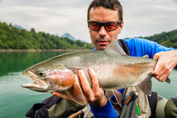 Fisherman with catch of Rainbow trout, Slovenia