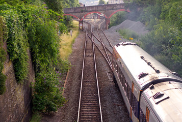 The train goes by rail. In the distance you can see the car bridge. Exeter. Devon. UK