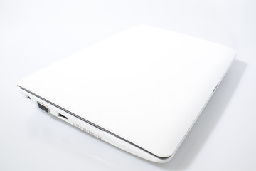 White laptop in a white background composition