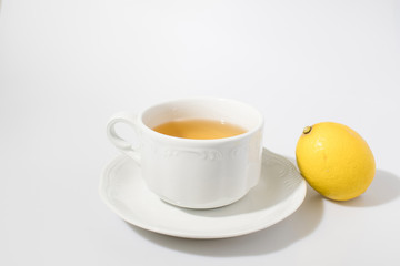 Cup of tea with lemon in a white backgorund