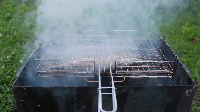 Cooking of three mackerels on a grill