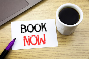 Handwriting Announcement text showing Book Now. Business concept for Reservation Buy Booking written on notebook book on the wooden background in the Office with laptop coffee