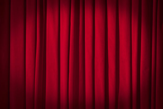 Red curtain theater background with folds, shadows and highlights.