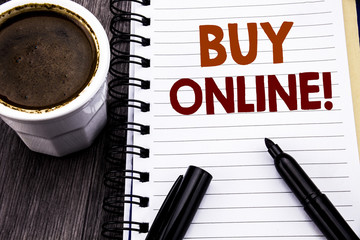 Writing text showing Buy Online. Business concept for E-commerce Sale Purchase written on notebook book note paper on the wooden wood background. With coffee and black marker.