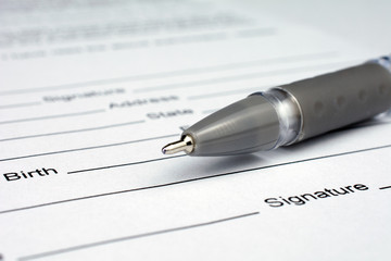 pen laying over a contract waiting to be signed