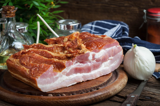 Raw bacon on a chopping board.