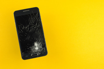 broken phone crack on the screen on a yellow background