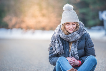 Young pretty woman on a road with snow in winter