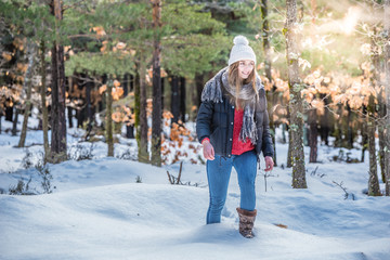 Fototapeta na wymiar Young beautiful woman in winter in the snow