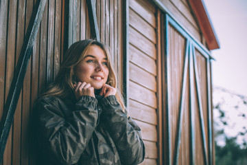 portrait Young pretty woman in winter in a log cabin in the snow