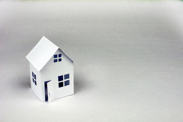 Obraz na płótnie Canvas white small house on white background, close up, selective focus Real Estate concept