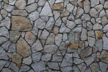 Old granite stone wall texture background close up